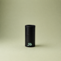 Black cylindrical object with 'Ak' branding on a beige background